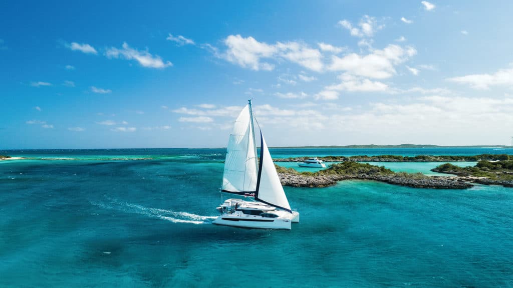 sailboat cruising on turquoise water